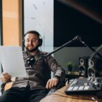 Portrait of happy young man working as radio host at radio station.