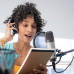 A Beautiful Young Black Woman With Curly Hair Reading Her Notes Script